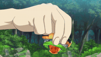 A Person 'S Hand Is Holding A Green And Orange Spinning Top GIF