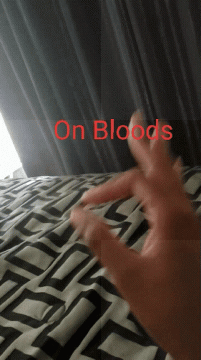 A Person 'S Hand Is Laying On A Bed With The Words " On Bloods " Above It GIF