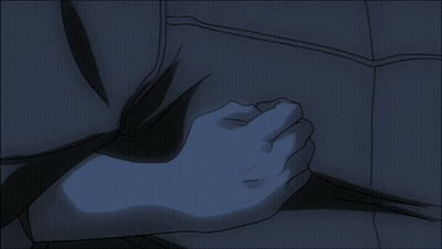 A Person 'S Hand Is On Another Person 'S Chest In A Dark Room GIF