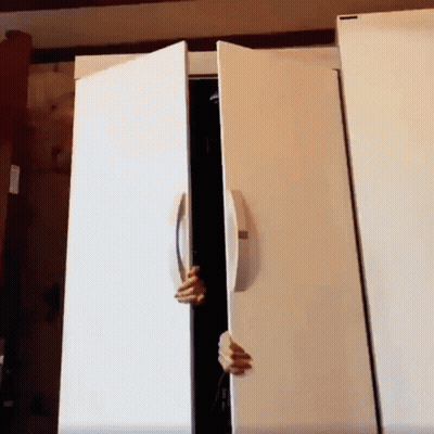 A Person 'S Hand Is Reaching Into A White Refrigerator Door GIF