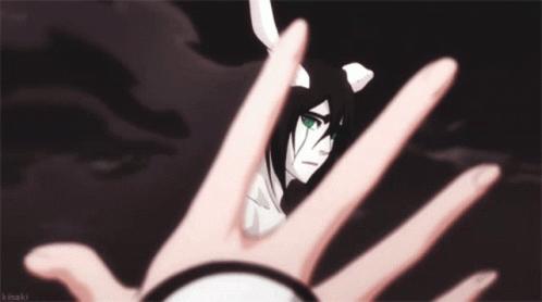 A Person 'S Hand Is Reaching Out Towards A Cartoon Character 'S Face GIF