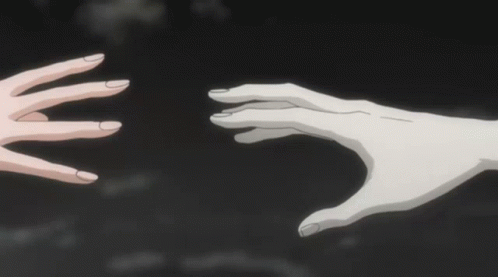 A Person 'S Hand Is Reaching Out Towards A Man With Horns GIF