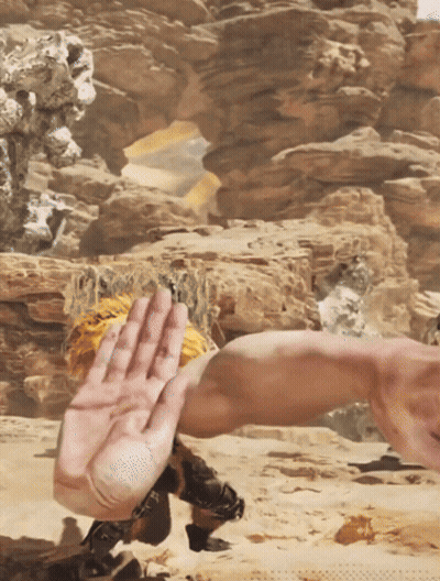 A Person 'S Hand Is Reaching Out Towards Another Person 'S Arm In The Desert GIF