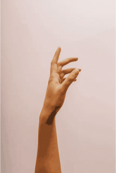 A Person 'S Hand Is Reaching Up In The Air GIF