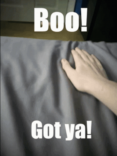 A Person 'S Hand Is Touching A Gray Cloth With The Words Boo Got Ya On It GIF