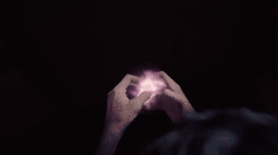 A Person 'S Hands Are Reaching Out Towards A Purple And Pink Circle GIF