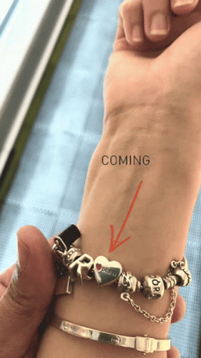 A Person 'S Wrist With An Arrow Pointing To The Word Coming On It GIF