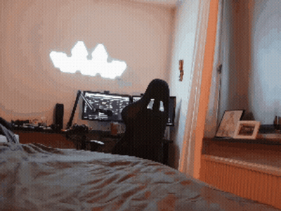 A Person Sits In A Chair In Front Of A Computer GIF