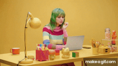 A Person Sitting At A Desk With A Laptop On It GIF