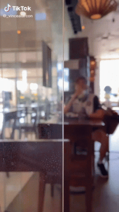 A Person Sitting At A Table In A Restaurant With A Tiktok Watermark On The Bottom GIF