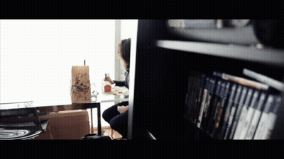 A Person Sitting At A Table With A Bag That Says ' A ' On It GIF