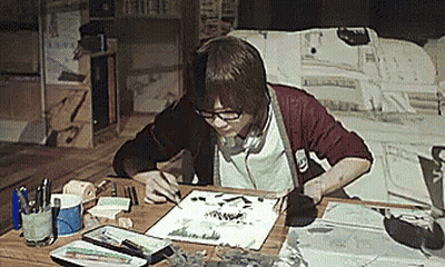 A Person Sitting At A Table With A Piece Of Paper That Says ' I ' On It GIF