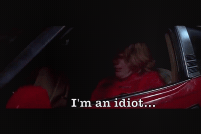 A Person Sitting In A Car With The Words I 'M An Idiot Below Them GIF