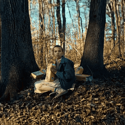 A Person Sitting In The Woods With A Bag Of Mcdonald 'S GIF
