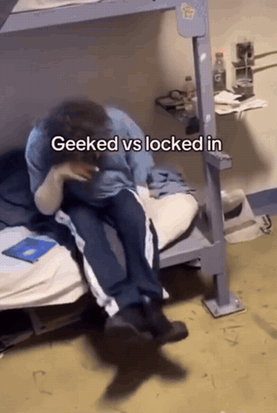 A Person Sitting On A Bed With The Words Geeked Vs Locked In GIF