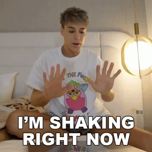 A Person Sitting On A Bed With The Words " I 'M Shaking Right Now " On The Bottom GIF
