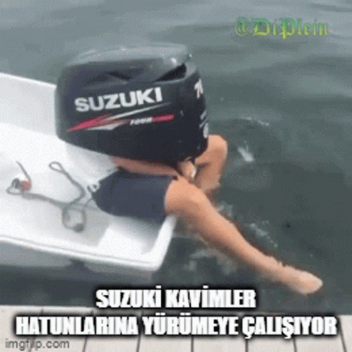 A Person Sitting On A Boat With A Suzuki Outboard Motor On Top Of Them GIF