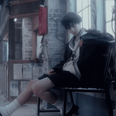 A Person Sitting On A Chair With A Backpack On The Back GIF
