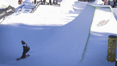 A Person Skiing Down A Snowy Slope With A Mountain Dew Sign On The Side GIF