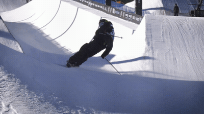 A Person Skiing Down A Snowy Slope With The Number 3 On The Back Of Their Jacket GIF
