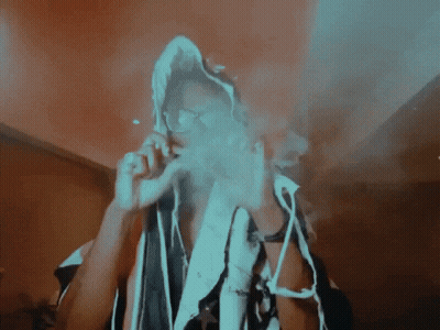 A Person Smoking A Cigarette With A Hood On GIF