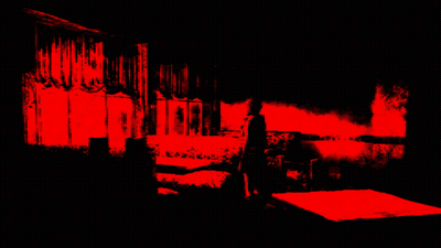 A Person Standing In A Dark Room With A Red Light Behind Them GIF