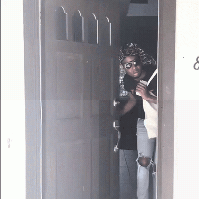 A Person Standing In A Doorway With The Number 8 On It GIF