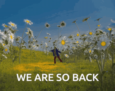 A Person Standing In A Field Of Daisies With The Words " We Are So Back " Below Them GIF