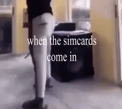 A Person Standing In A Room With The Words " When The Simcards Come In " GIF