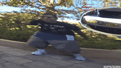 A Person Standing In Front Of A Car With The Number 32375 On The Bottom Right GIF