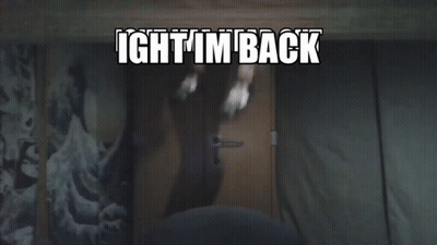 A Person Standing In Front Of A Door With The Words Ight I 'M Back Written Above Them GIF
