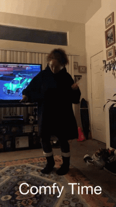 A Person Standing In Front Of A Television With The Words " Comfy Time " Written Below Them GIF
