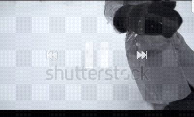A Person Standing In The Snow With A Shutterstock Logo In The Corner GIF