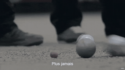 A Person Standing Next To A Ball That Has The Word Plus Jamais On It GIF