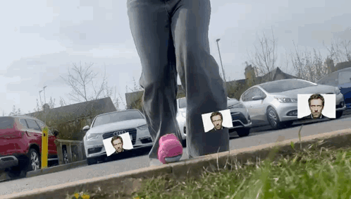 A Person Standing On A Curb With A Picture Of A Man On It GIF