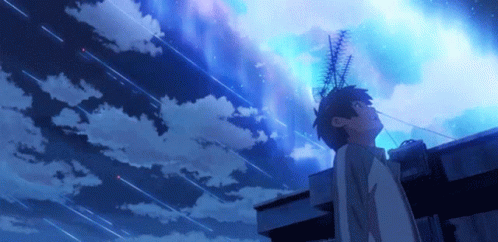 A Person Standing On A Roof Looking Up At A Starry Sky GIF