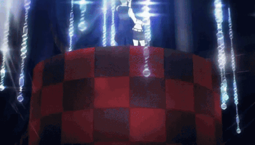 A Person Standing On Top Of A Red And Black Checkered Table In A Dark Room GIF