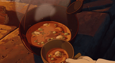 A Person Stirring A Pot Of Soup With A Spoon GIF