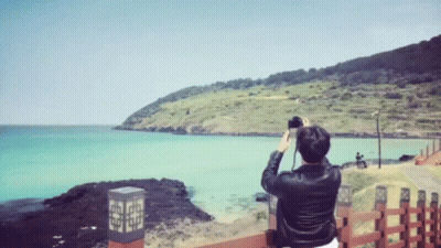A Person Taking A Picture Of A Body Of Water GIF