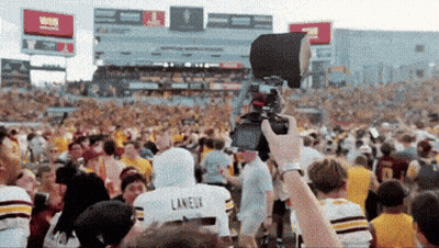 A Person Taking A Picture Of A Crowd With A Laneux Jersey On GIF