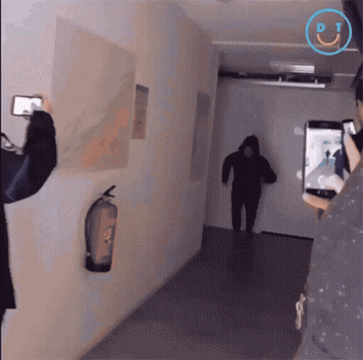 A Person Taking A Picture Of A Person In A Hallway With A Dt Logo On The Bottom GIF
