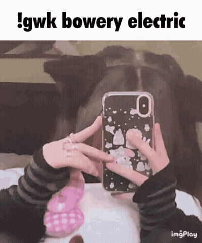 A Person Taking A Picture Of Themselves With A Phone Case That Says Gwk Bowery Electric GIF