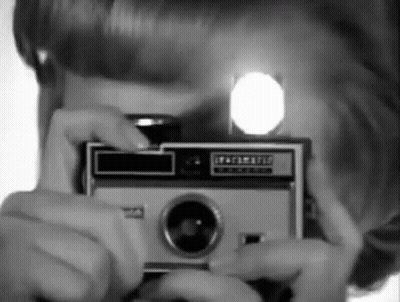 A Person Taking A Picture With A Kodak Camera GIF