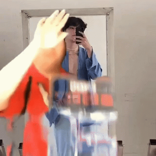 A Person Taking A Selfie In Front Of A Mirror GIF