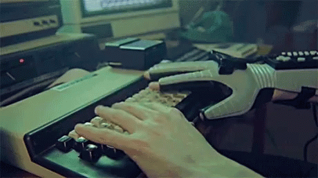 A Person Typing On A Keyboard With A Glove On GIF