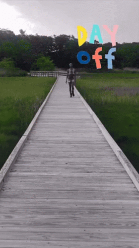 A Person Walking Down A Wooden Boardwalk With Day Off Written On The Bottom GIF