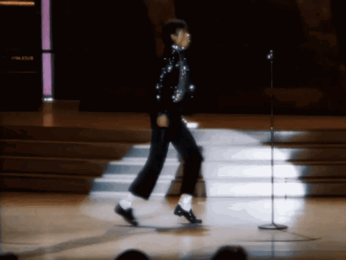 Person Walking On Stage With Microphone GIF