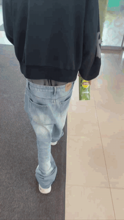A Person Walking With A Bag Of Lays Chips In Their Hand GIF