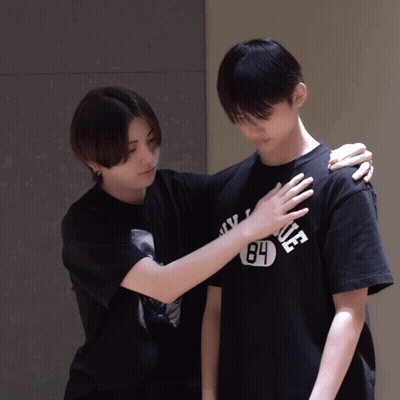 A Person Wearing A 84 T-Shirt Holds Another Person 'S Shoulder GIF
