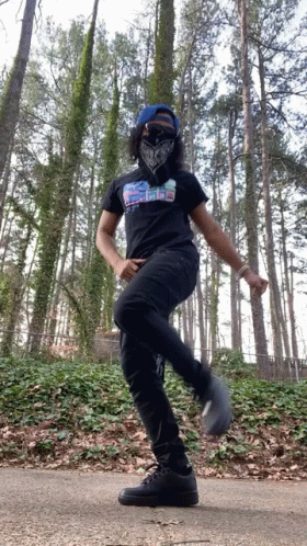 A Person Wearing A Bandana And A Shirt That Says ' Peace ' On It Is Dancing GIF